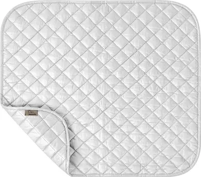 A white quilted ironing mat is shown from a top-down perspective, with one corner folded back.
