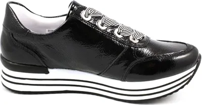 A black patent leather sneaker with a platform sole and striped laces is shown from the side against a white background.