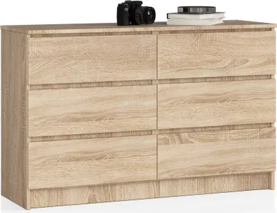 A dresser with six drawers is shown against a white background. A camera and some books are on top of the dresser.