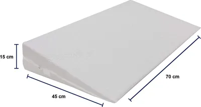 A white wedge pillow with dimensions indicated by measurement lines and text.