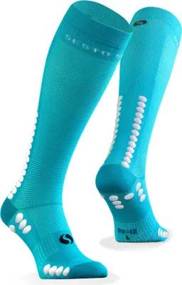 A pair of turquoise knee-high sports socks with white dots arranged in a pattern.