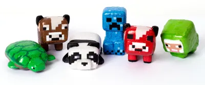 A collection of small, pixelated toy figures resembling Minecraft characters arranged on a white background.