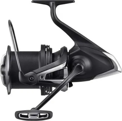 A side view of a black fishing reel against a white background.