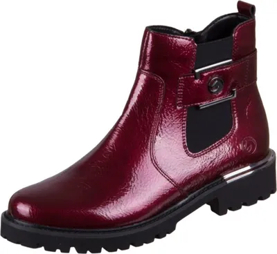A single red patent leather ankle boot with a black sole and silver buckle detail, presented against a white background.