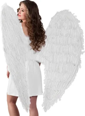 A woman wearing large white angel wings.