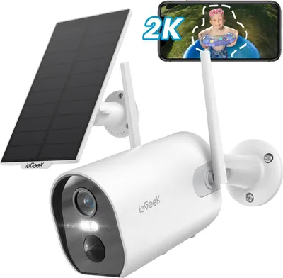 A white security camera with a solar panel and a smartphone displaying a video feed of a child.