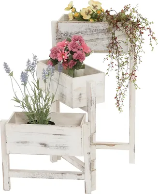 A tiered wooden planter with artificial flowers.