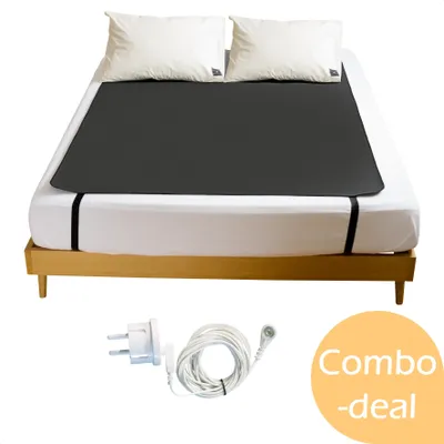 A grounding mat is shown on a bed with pillows, along with a power cord and adapter.