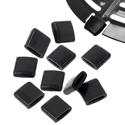 A collection of black rubber bumpers, possibly for an air fryer, arranged on a white background.