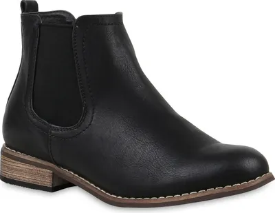 A black Chelsea boot is shown from the side against a white background.