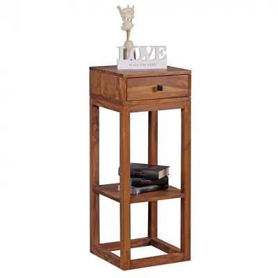 A wooden side table with a drawer and two shelves, decorated with a white 'LOVE' sign and a small figurine.