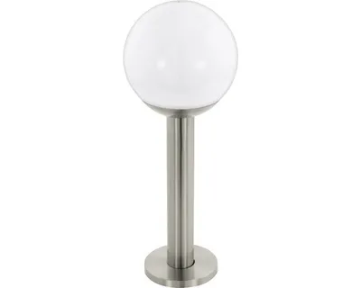 A white globe light fixture on a silver pole.