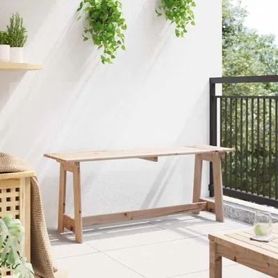 A wooden bench on a balcony with plants and a drink.