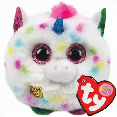 A close-up studio shot of a fluffy, round, white unicorn plush toy with colorful polka dots and glitter accents. A red heart-shaped TY tag is attached to the toy.