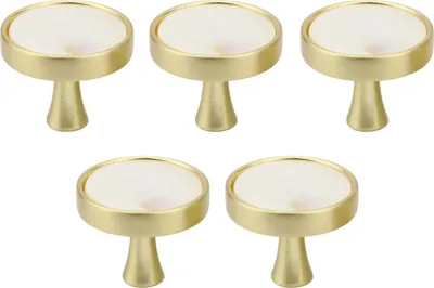 Five cabinet knobs with gold bases and white marble tops are arranged in a grid on a white background.