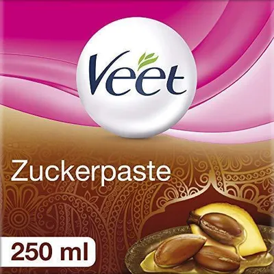 The image shows the packaging of Veet Zuckerpaste, a hair removal product, with the brand logo and product name prominently displayed. It also features an illustration of argan nuts and oil, suggesting ingredients.