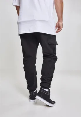 A person wearing black cargo jogging pants and black high-top sneakers, shown from the back.