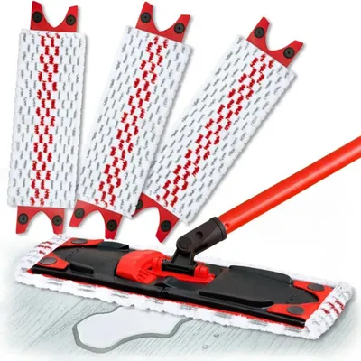 A set of mop heads and a mop handle are displayed on a light-colored wooden floor with a small puddle of water.