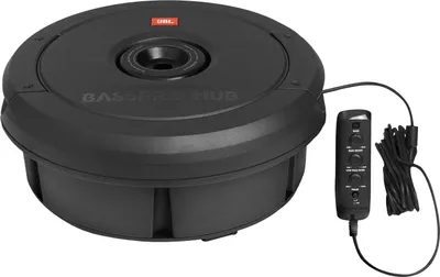 A black JBL BassPro Hub subwoofer is shown on a white background, with its remote control and cable to the side.