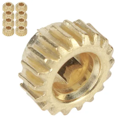 A group of small brass gears and one larger brass gear are shown against a white background.