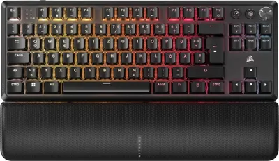A close-up, top-down view of a black mechanical keyboard with RGB lighting and a textured wrist rest.
