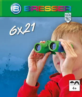 A child is looking through green binoculars against a blurred blue and green background.