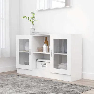 A white sideboard cabinet with glass doors is shown in a room with a gray rug and a mirror on the wall.