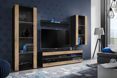 A modern living room with a media console, tall display cabinet, and a wall-mounted shelf.