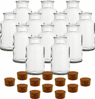 A set of clear glass jars with cork stoppers arranged on a white background.