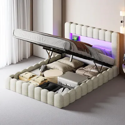 A bed with its storage compartment open, revealing stored items and LED lighting in the headboard.