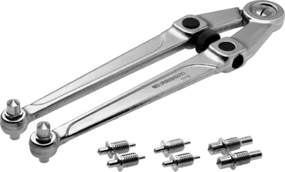 A pair of metal tools and several small metal parts are arranged on a white background.