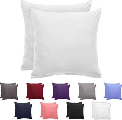 A display of multiple pillow covers in various colors, with two white pillow covers prominently featured at the top.