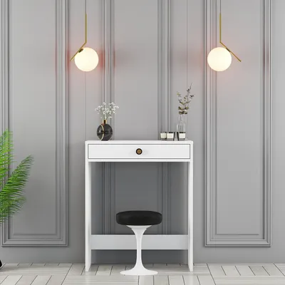 A white vanity table with a black stool in front of a grey paneled wall, with two pendant lights hanging above.