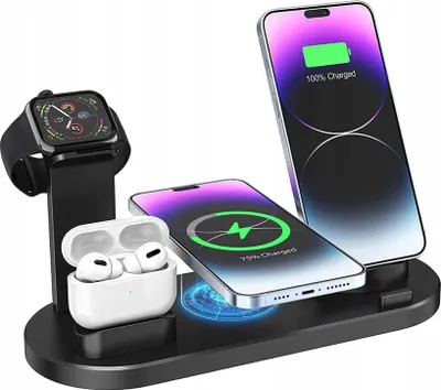 A black charging stand with an Apple Watch, AirPods, and two iPhones on it, all in various stages of charging.