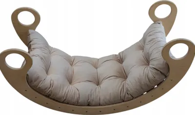 A light beige cushion on a wooden rocking cradle.