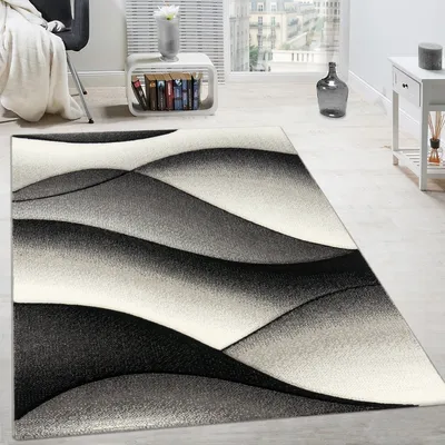Immagine prodotto di Tappeto di design moderno con motivo astratto a onde e taglio sagomato, colore grigio antracite, dimensioni 60x110 cm