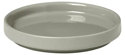 A close-up studio shot of a single, light gray ceramic plate with a slightly raised rim, presented against a plain white background.