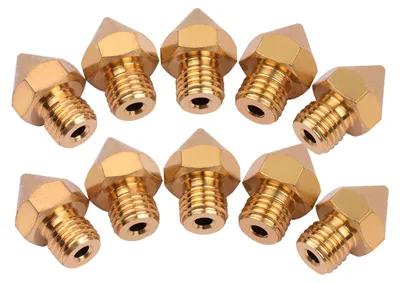 A group of brass 3D printer extruder nozzles are arranged on a white background.
