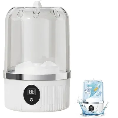 A white portable mini washing machine with a clear lid, shown on a white background. A smaller inset image shows the machine in use with water and cartoon fish.