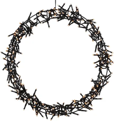 A circular wreath made of black wires and small lights.