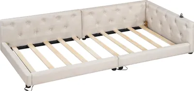 A beige upholstered daybed frame with wooden slats is shown from a slightly elevated, diagonal angle.