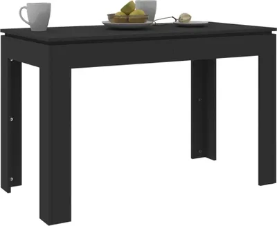 A black dining table with two cups and a plate of fruit on top, set against a white background.