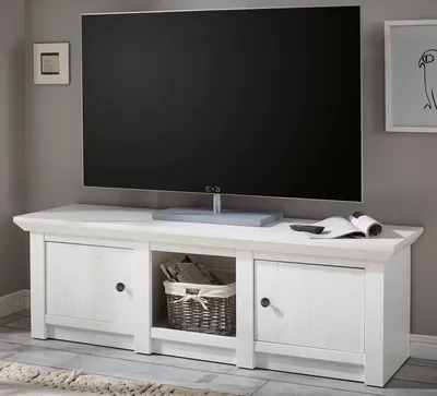 A TV lowboard with a TV on top, in a room setting.