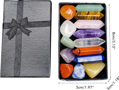 A gift box next to an open box containing various polished crystals.
