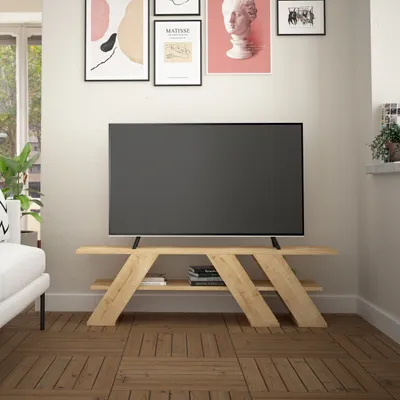 A modern living room with a TV stand and a large television.