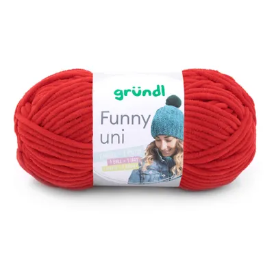 A ball of red yarn with a label showing a woman wearing a knitted hat.