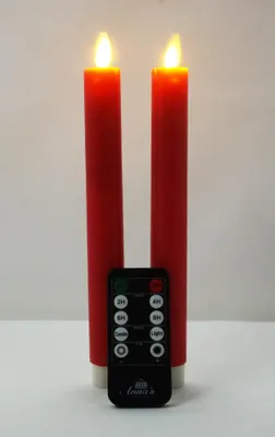 Two red LED candles with a remote control in front of a white background.