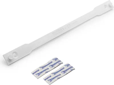 A white plastic cable tie and two desiccant packets on a white background.