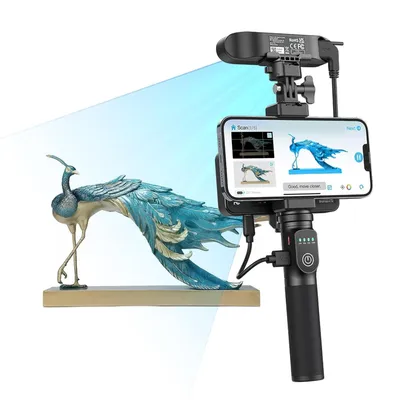 A 3D scanner setup with a smartphone and a peacock sculpture.