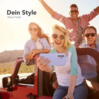 Four young people are enjoying a road trip in a red jeep, with the sun setting in the background. One person is taking a selfie with a purple phone case.